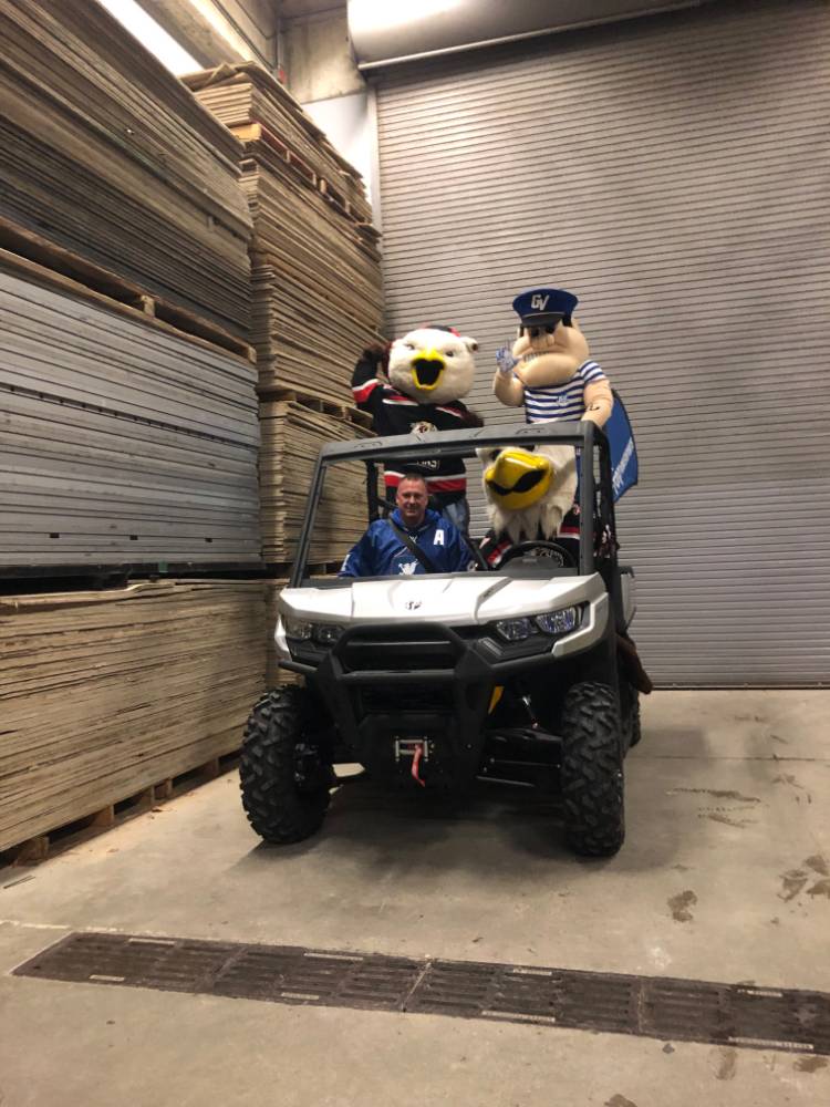 louie with the griffins mascots on the buggie